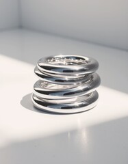 Poster - Reflective chrome shapes stacked on a white background