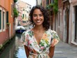 © Tetiana - Happy young woman in floral dress by Venice canal during daytime