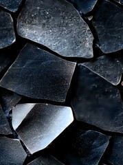 Poster - Dark geometric fragments of broken glass create abstract pattern with metallic sheen and sharp edges, dramatic lighting highlights textural details and shadows.