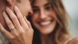© Snowstudio - Man and woman smiling while showing engagement ring outdoors
