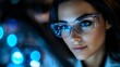 © Yuliia - Young woman in transparent glasses with blue neon lights and bokeh effects in dark background creating modern urban nightlife atmosphere for lifestyle and fashion concepts.