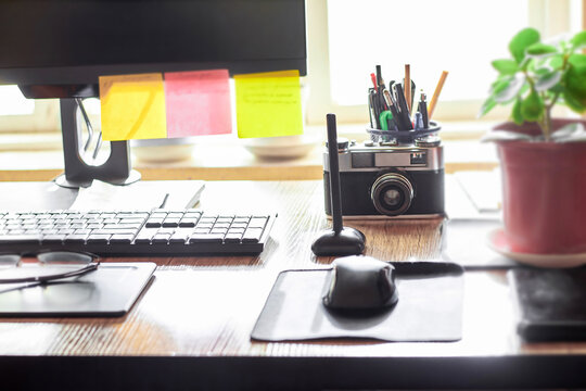 Workplace of a freelance graphic designer at a computer