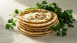© SHALINA - Stack of homemade flatbreads with fresh parsley