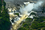 Aerial view of Iguazu Falls, a monumental waterfall system on the Iguazu River surrounded by lush green forests. -Panoramic view of the border between Brazil and Argentina, South America