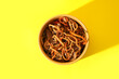 © Pixel-Shot - Bowl of tasty Chinese noodles with vegetables and meat on yellow background