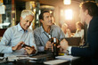 © Marko Geber - Diverse group of male businessman having a beer and celebrating closing a deal on their job