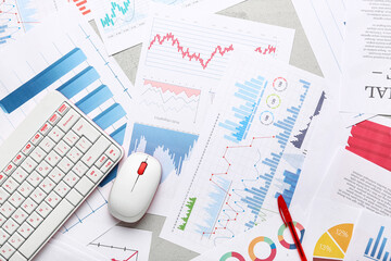 Fototapete - Computer mouse with keyboard, many business graphics and diagrams on grey background
