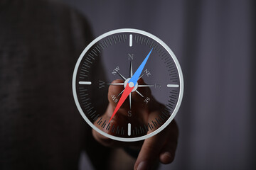 Aufkleber - Person using a digital compass for navigation.  Find your direction.