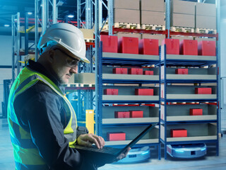 Poster - Man storekeeper. Worker controls AMR via laptop. Man developing warehouse technologies. Robotic storage area. Robots move warehouse racks. Developer warehouse robots. Storekeeper in helmet and vest