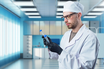Poster - Man doctor with test tubes. Plastic flasks in hands of man nurse. Young doctor in clinic room. Medical specialist. Doctor examines flasks with tests. Hospital employee in white coat and hat