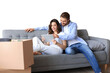 © ty - Happy couple sitting and planning new home decoration at home with a tablet at moving day, renovation and interior design for new house on a transparent background
