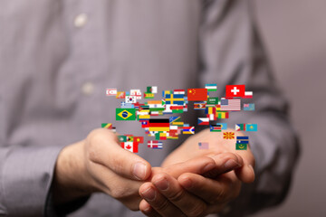 Poster - Image of hands holding many flags representing global business, international trade, and world connections.