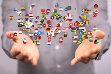 Poster - Image of hands gently holding numerous flags, symbolizing global unity and international collaboration.