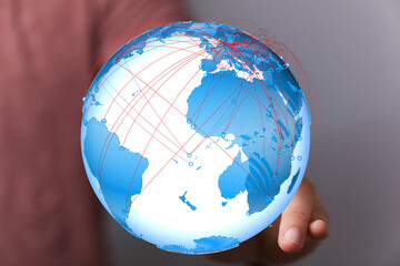 Poster - High-quality image of a hand holding a digital globe, illustrating global connectivity and communication.