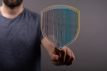 Poster - Image of a person interacting with a digital shield, representing cybersecurity and data protection.