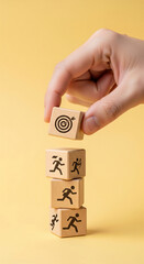 Poster - Hand placing wooden cube with target symbol atop stack of cubes showing running figures, illustrating goal achievement and competitive strategy