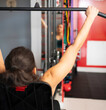 © VictorCanalesStudio - Determined sportswoman strengthening back muscles, pulling weights in gym machine Healthy lifestyle concept