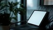 © Dewi - Tablet resting on a dark leather chair in a modern interior (1)