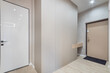 © Alhim - A contemporary hallway showcases minimalist design with light wood flooring, modern wall panels, and stylish doors. It creates an inviting atmosphere for residents and guests alike.