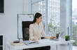 © Kritdanai - Asian Businesswoman Working at Desk with Laptop