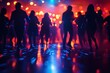 © fatman - People dancing on a vibrant dance floor at a lively party during the evening with dynamic lighting effects creating an energetic atmosphere