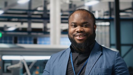 Poster - african american technician analyst in a solar manufacturing plant evaluates operations, dressed in 