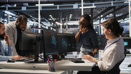 Poster - Smiling technicians doing fist bump in data center after successful deployment of AI tools. Server room engineering team celebrate completion of machine learning system integration, camera A