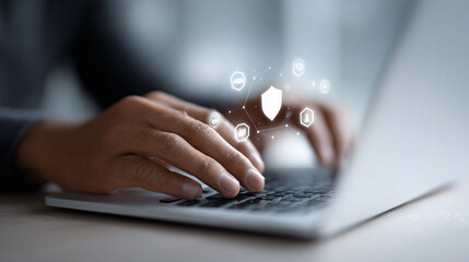 Poster - Cybersecurity protection concept. Close up on person typing on a laptop with security icons. Perfect for illustrating online safety, data privacy and secure access.