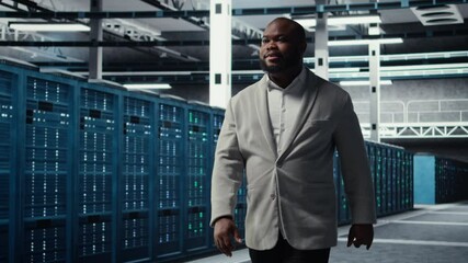 Poster - Smiling engineer in server hub monitoring data center energy consumption across components. Happy IT expert walking in data center, making sure rigs sensors are functioning optimally