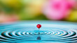 © Nayotsaphon - Close-Up of Red Droplet Creating Ripples in Blue Water Surface