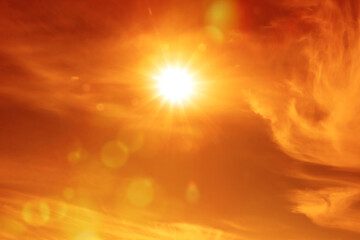 Wall Mural - orange sky with sun and clouds during hot summer weather. extremely high temperature