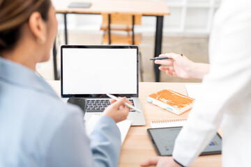 Fototapete - Mockup image of a two woman using laptop with blank screen on wooden table