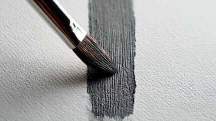 Poster - Close-up of a paintbrush applying dark gray paint to a textured white wall with a detailed view of brush strokes and wall surface