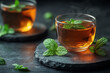 © maxa0109 - Cup of hot tea with green mint leaves