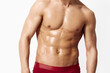© SHOTPRIME STUDIO - Muscular man posing confidently in red swim trunks, showcasing fitness and strength. Gym and wellness concept with a healthy lifestyle focus.