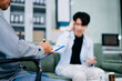 © Nuttapong punna - Young Asian man discusses mental health with psychiatrist in office. Emotional support, anxiety, therapy, and compassionate care.