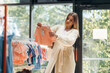 © standret - Woman is choosing wear in the kid's clothing store