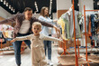 © standret - Father, son and pregnant mother are in kid's clothing store