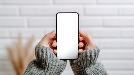 Poster - Woman Holding Smartphone with Blank Screen in Hands Close Up in Indoor Setting