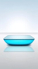 Poster - Modern blue glass tray with curved edges and reflective surface on plain background