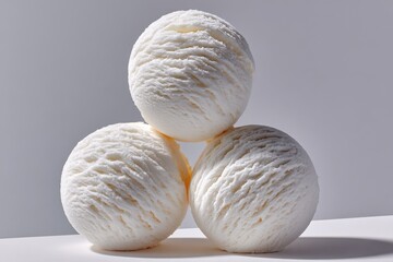 Aufkleber - Close-up of three white scoops of ice cream arranged in a pyramid shape on a plain light gray background with soft shadows
