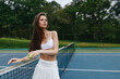 © SHOTPRIME STUDIO - Young athletic woman in sporty outfit playing tennis on an outdoor court surrounded by lush greenery, showcasing confidence and enjoyment in her sport