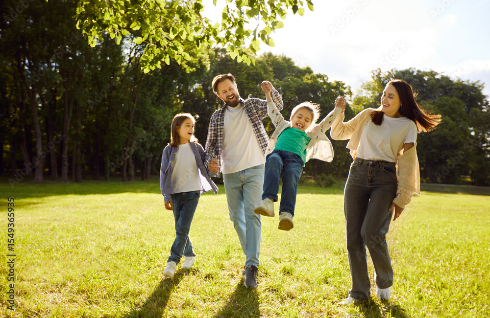 Happy family walking and playing together outdoors in summer green ...