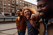 © bernardbodo - Three young men laughing and walking in the city