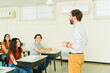 © AntonioDiaz - High school teacher giving lesson to students in classroom