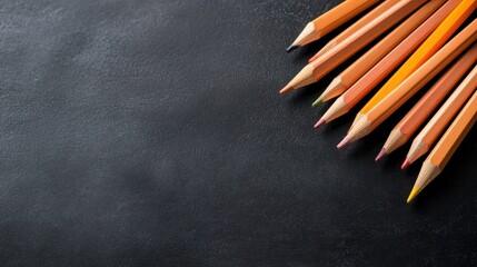 Poster - An aesthetic arrangement of colored pencils on a smooth black surface, perfect for artistic endeavors and creative expression in various projects.
