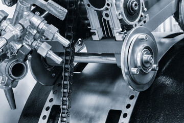 Poster - chain is attached to a red engine. The chain is made of metal and is attached to engine blue tone industrial concept background