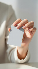 Aufkleber - Close-up of hand holding blank light-grey card, showcasing clean minimalist design ideal for mockup, advertisement, or branding, conveying simplicity and elegance