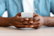 © Prostock-studio - Closeup Shot Of African American Man Sitting At Desk And Using Smartphone, Cropped Image Of Unrecognizable Black Guy With Mobile Phone In Hands Texting With Somebody Or Browsing New App