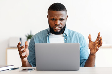 Poster - Deadline Stress. Annoyed black man sitting at workplace looking at laptop screen, african american freelancer guy suffering business problems while working online on computer at home office